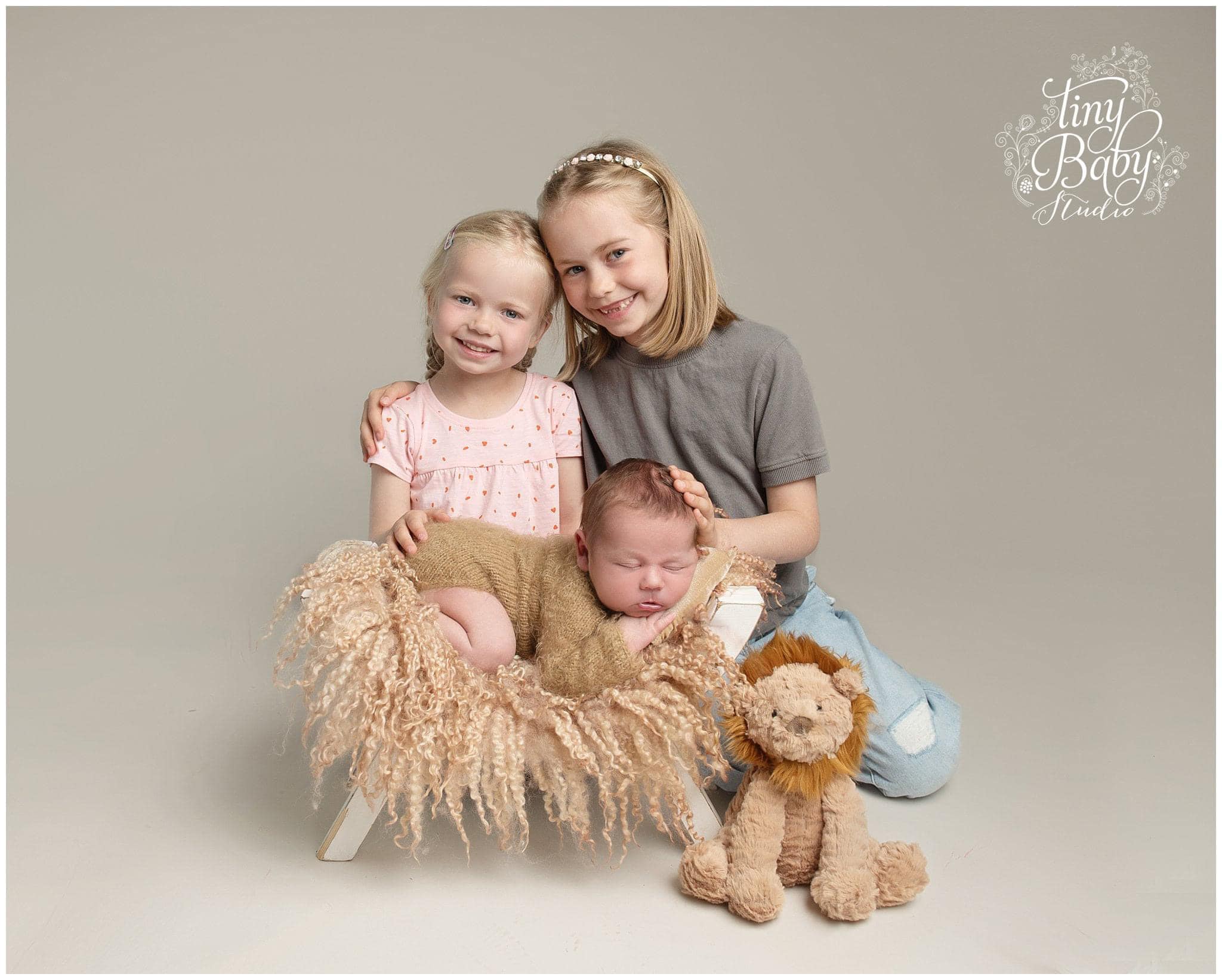 Older Sisters with Newborn at Tiny Baby Studio