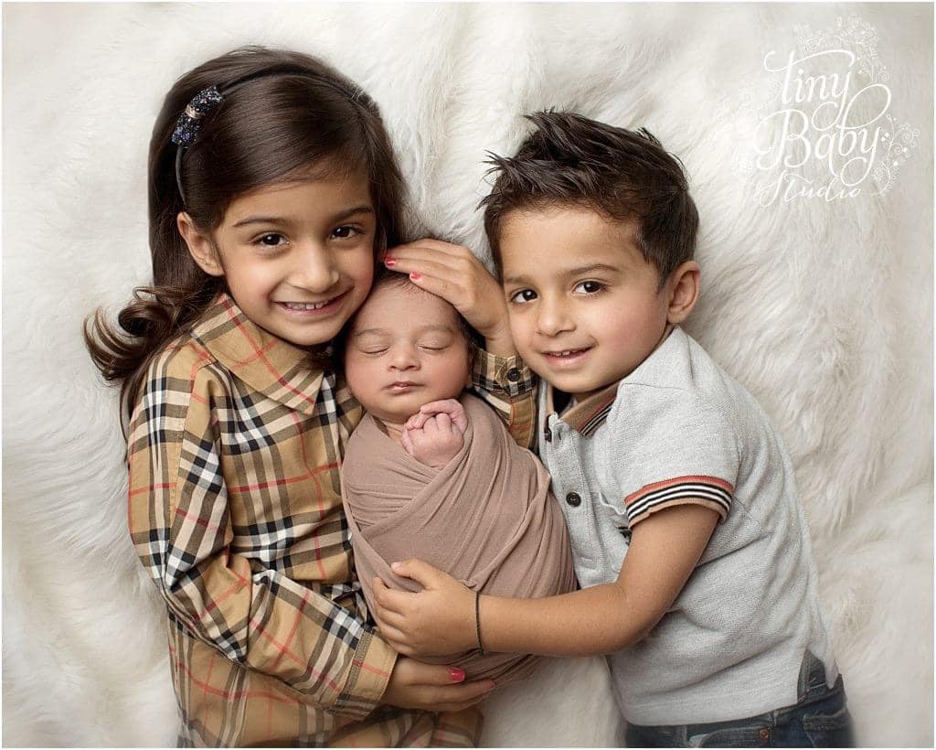 Brother and Sister with Newborn at Tiny Baby Studio